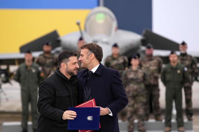 Le président de la République, Emmanuel Macron, et le président ukrainien, Volodymyr Zelensky, se félicitent après la signature d’une lettre d’intention portant sur l’acquisition de 100 avions de chasse Rafale et de leur armement, sur la base aérienne de Villacoublay (Yvelines), le 17 novembre 2025. 